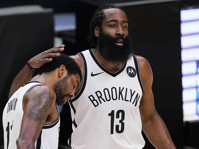 Brooklyn Nets guard Kyrie Irving, left, gets a pat on the head from guard James Harden. Picture: Mark J. Terrill/AP