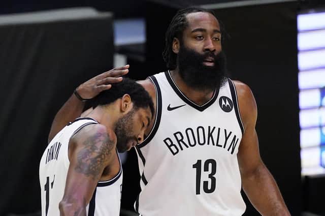 Brooklyn Nets guard Kyrie Irving, left, gets a pat on the head from guard James Harden. Picture: Mark J. Terrill/AP