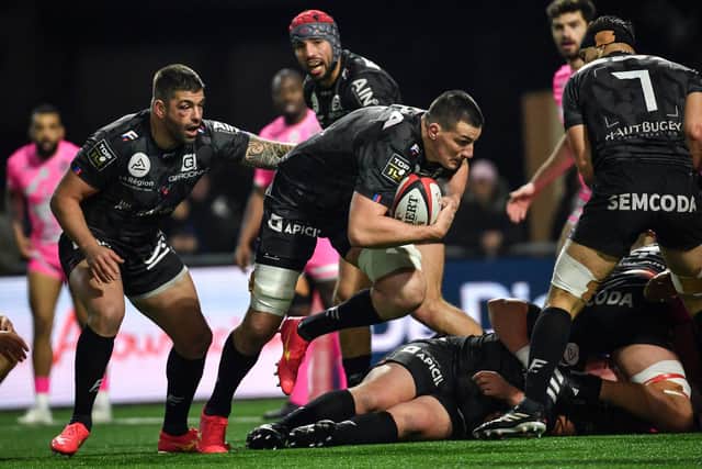 Oyonnax' Scottish lock Ewan Johnson takes the ball into contact during a French Top 14 match against Stade Francais at the Charles-Mathon Stadium in Oyonnax, western France, on February 3, 2024.  (Photo by ARNAUD FINISTRE/AFP via Getty Images)