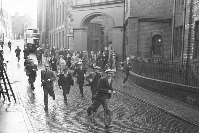 Staff leave the factory in 1951 when the North British Rubber Company's works at Castle Mills employed 3,664 people.