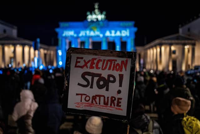 A protester, at a rally in Berlin in support of the popular 'Woman, Life, Freedom' uprising in Iran, calls for an end to torture and execution in the country (Picture: John MacDougall/AFP via Getty Images)