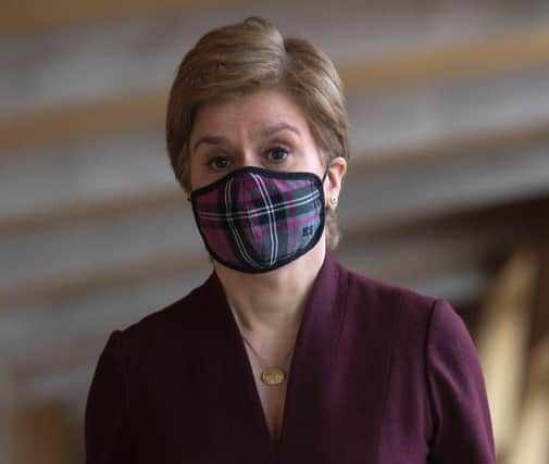 Nicola Sturgeon said people should continue to wear face coverings in shops and on public transport (Picture: Fraser Bremner-Pool/Getty Images)