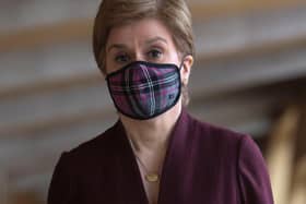 Nicola Sturgeon said people should continue to wear face coverings in shops and on public transport (Picture: Fraser Bremner-Pool/Getty Images)