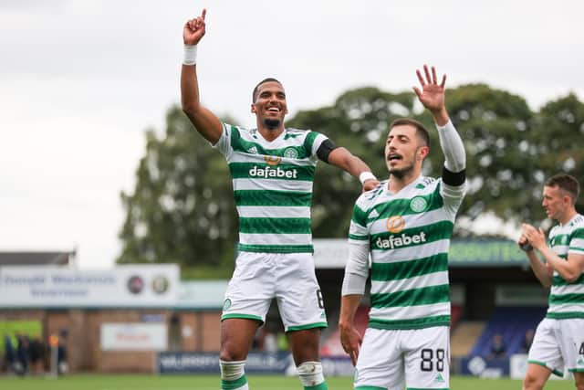 Moritz Jenz, left, celebrates with the Celtic fans at full time.
