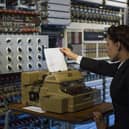 A member of staff at the National Museum of Computing demonstrates how the Colossus computer was used during the Second World War at Block H, Bletchley Park (Picture: Jack Taylor/Getty Images)