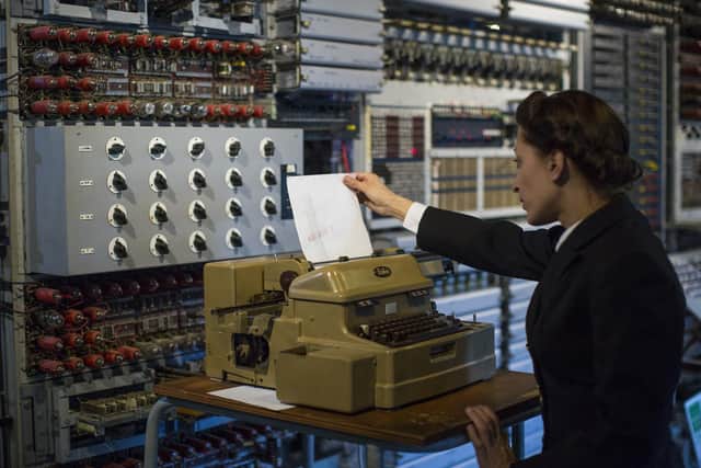 A member of staff at the National Museum of Computing demonstrates how the Colossus computer was used during the Second World War at Block H, Bletchley Park (Picture: Jack Taylor/Getty Images)