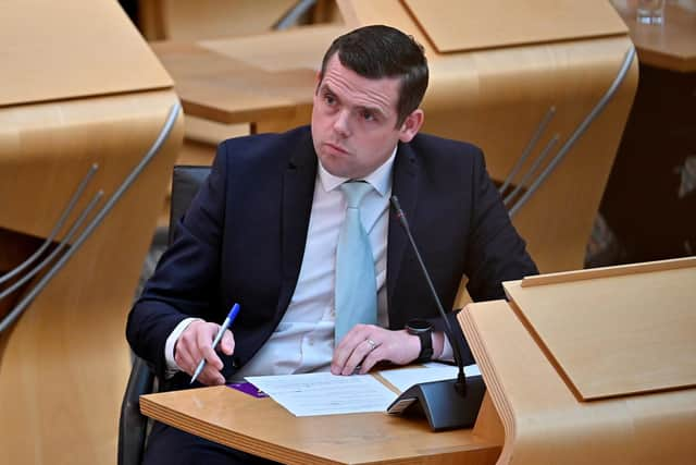 Douglas Ross Leader of the Scottish Conservative Party listens to First Minister Nicola Sturgeon during the statement at the Scottish Parliament in Edinburgh, on the next stage of lockdown easing on June 1, 2021