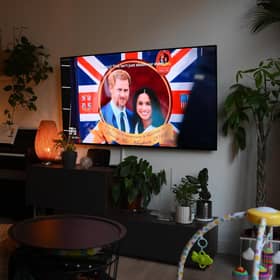 A woman watches an episode of the newly released Netflix docuseries "Harry and Meghan" about Britain's Prince Harry, Duke of Sussex, and Britain's Meghan, Duchess of Sussex, in London. Picture: Daniel Leal/AFP via Getty Images