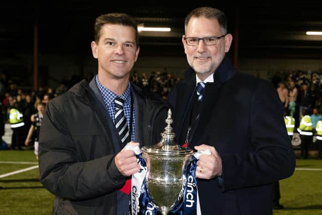 Dundee owner Tim Keyes, left, and managing director John Nelms with the trophy after watching the club win the Championship at Ochilview.