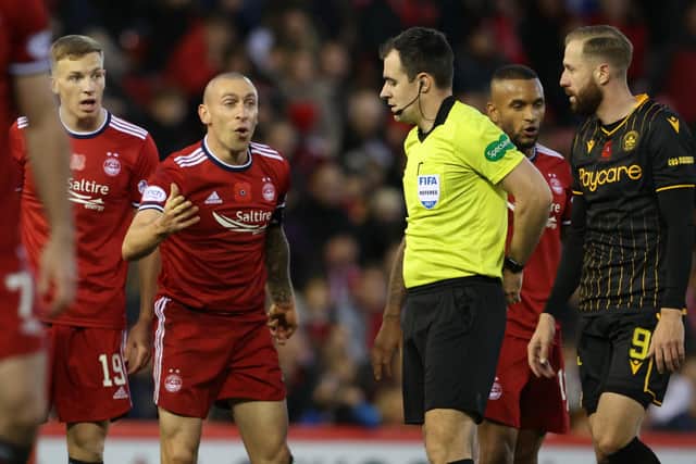 Aberdeen's Scott Brown (left) speaks to referee Don Robertson during the defeat by Motherwell.