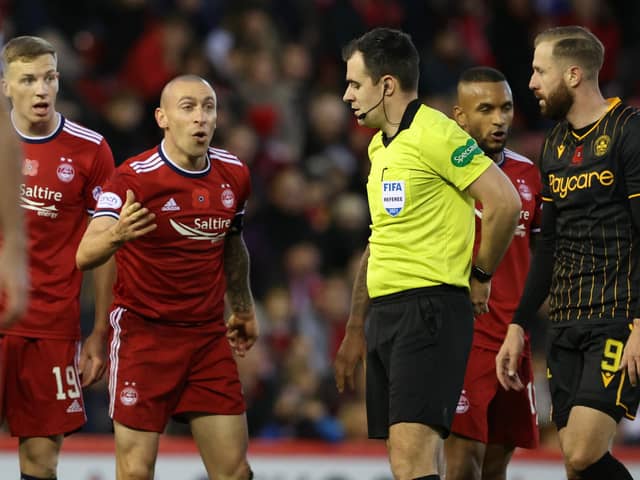 Aberdeen's Scott Brown (left) speaks to referee Don Robertson during the defeat by Motherwell.
