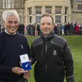 Clive Brown, the new Captain of The Royal and Ancient Golf of St Andrews, presents a Gold Sovereign to caddie Martin O’Brien.