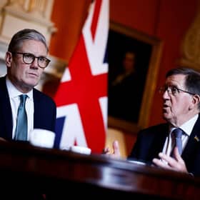 Former defence secretary Lord Robertson, pictured right with Sir Keir Starmer, says Britain needs to 'move away from a peacetime mode' and households should prepare for attacks by stocking up on candles and battery-operated torches and radios (Picture: Benjamin Cremel - WPA Pool/Getty Images)