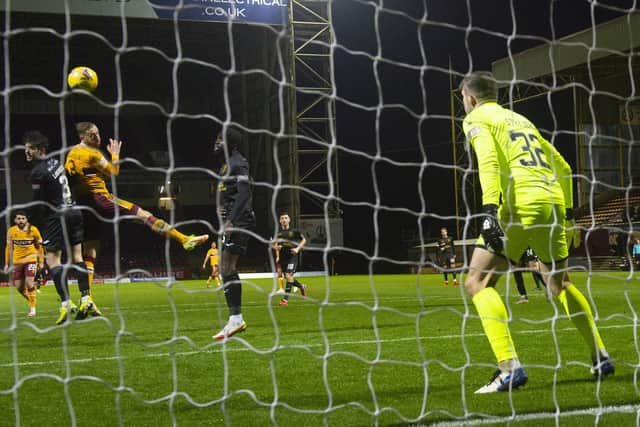 Motherwell's Kevin van veen beats Livingston's Max Stryjek with a header to make it 2-0 during a Cinch Premiership match between Motherwell and Livingston at Fir Park, on December 26, 2021, in Motherwell, Scotland.  (Photo by Alan Harvey / SNS Group)