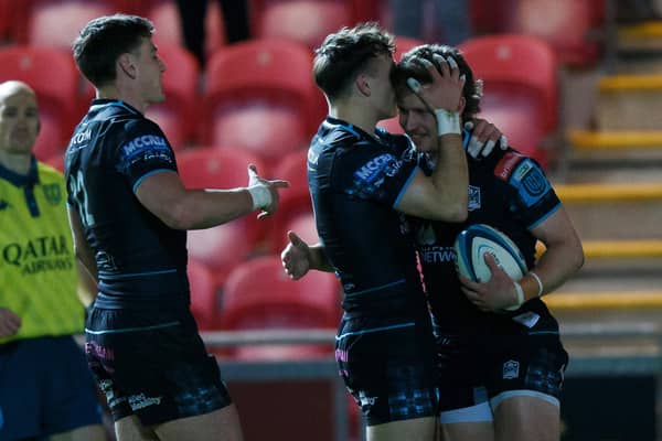 Kyle Rowe of Glasgow celebrates with team-mates after scoring his second try against Scarlets.
