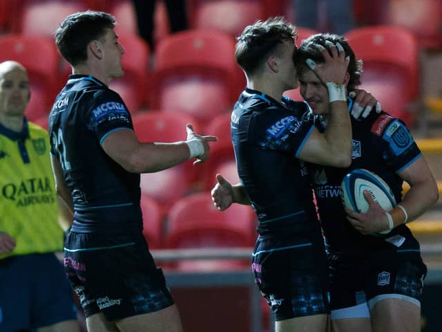 Kyle Rowe of Glasgow celebrates with team-mates after scoring his second try against Scarlets.