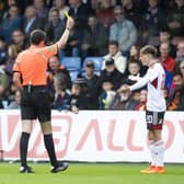 Aberdeen's Leighton Clarkson is booked for a challenge on Ross County's Callum Johnson.