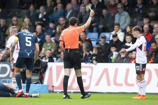 Aberdeen's Leighton Clarkson is booked for a challenge on Ross County's Callum Johnson.