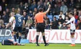 Aberdeen's Leighton Clarkson is booked for a challenge on Ross County's Callum Johnson.