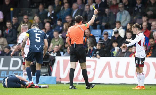 Aberdeen's Leighton Clarkson is booked for a challenge on Ross County's Callum Johnson.