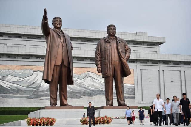 People leave after paying their respects before the statues of late North Korean leaders Kim Il Sung and Kim Jong Il at Mansu Hill this week as North Korea marks its 78th National Liberation Day, commemorating the end of Japanese colonial rule at the end of World War II. The country is just beginning to allow citizens to return after the Covid pandemic.