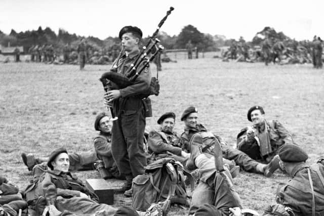 Bill Millin plays his pipes to troops in 1944. PIC: IWM/CC.