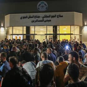 People evacuated from Sudan arrive at a military airport in Amman. Foreign Secretary James Cleverly has said the UK is contacting British nationals directly with routes for an evacuation out of Sudan.

 (Photo by KHALIL MAZRAAWI/AFP via Getty Images)