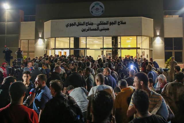 People evacuated from Sudan arrive at a military airport in Amman. Foreign Secretary James Cleverly has said the UK is contacting British nationals directly with routes for an evacuation out of Sudan.

 (Photo by KHALIL MAZRAAWI/AFP via Getty Images)