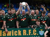 The Hawick players celebrate with the trophy after winning the Tennent's Premiership final against Currie Chieftains.