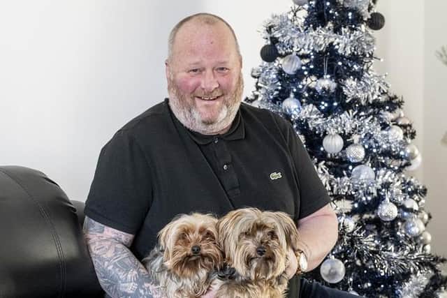 Bobby Jones with his two Yorkshire terriers in his new Irvine home