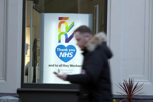 A man walks past the Rainbow Room hairdressers in Glasgow's Royal Exchange Square. Picture: Andrew Milligan/PA Wire