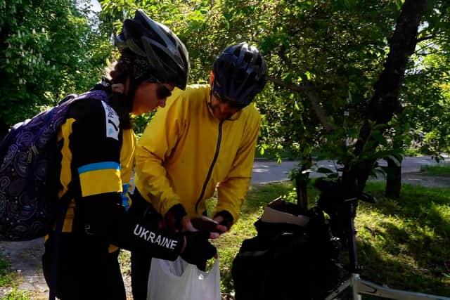 Viktoria and Aleksander, cycle volunteers , arrive with a food basket for local elderly residents of Kharkiv.