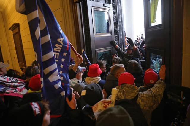 As votes were still being counted in Georgia, protesters over-ran police stationed outside the Capitol, where Vice President Mike Pence was acting in his ceremonial role as President of the Senate. (Photo by Win McNamee/Getty Images)