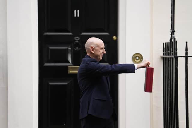 Chancellor John Healey poses for photographs as he leaves 11 Downing Street.
