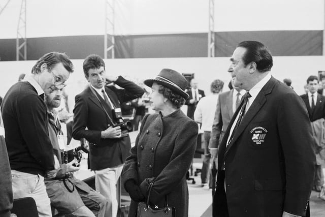 The soon-to-be-disgraced businessman Robert Maxwell introduces the press to Queen Elizabeth II at the press centre for the Commonwealth Games.
