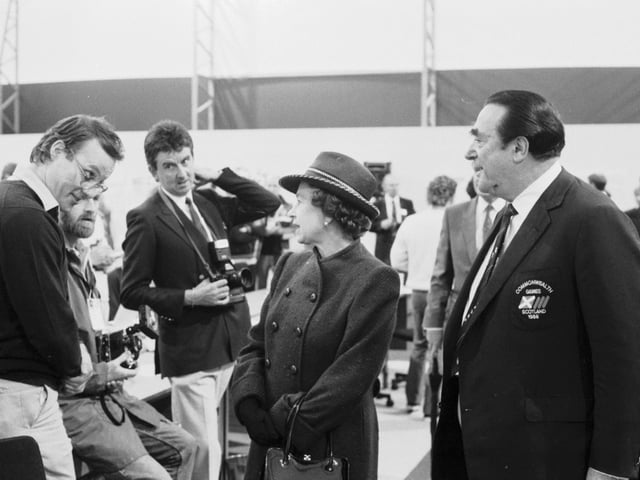 The soon-to-be-disgraced businessman Robert Maxwell introduces the press to Queen Elizabeth II at the press centre for the Commonwealth Games.