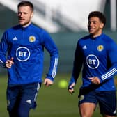 Leeds United skipper Liam Cooper leads the charge at Scotland training yesterday with Nathan Patterson (left) and Che Adams (right)  (Photo by Craig Williamson / SNS Group)