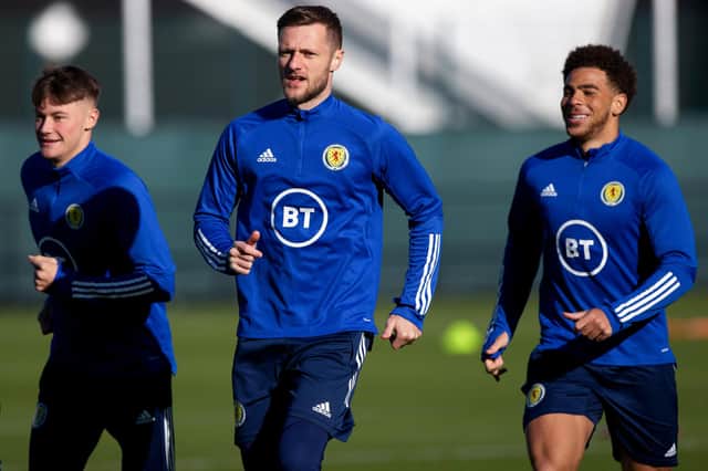 Leeds United skipper Liam Cooper leads the charge at Scotland training yesterday with Nathan Patterson (left) and Che Adams (right)  (Photo by Craig Williamson / SNS Group)