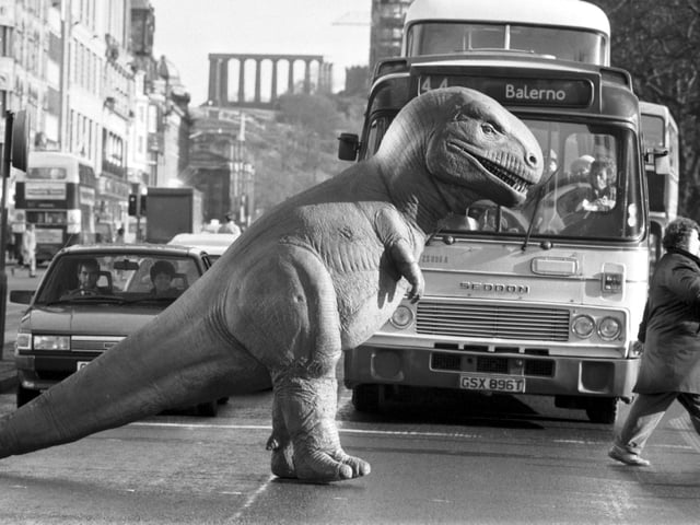 One of the exhibits from the Dinosaurs Alive! exhibition at the City Art Centre stops the traffic in Princes Street, February 1990.