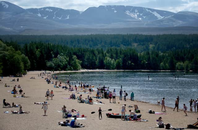 Loch Morlich on the edge of the Glenmore Forest near Aviemore is one of the 'hot spots' in the Cairngorms National Park that visitors are being urged to avoid this weekend. PIC: PA.