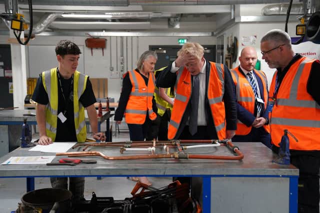 Boris Johnson, centre, meeting student Cassidy, left, at Blackpool and The Fylde College. Picture: Peter Byrne/Pool via AP
