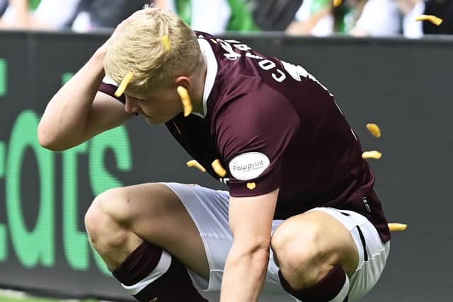 Hearts defender Alex Cochrane cowers as he is struck by objects thrown from the Hibs support during Sunday's Edinburgh derby at Easter Road. (Photo by Rob Casey / SNS Group)