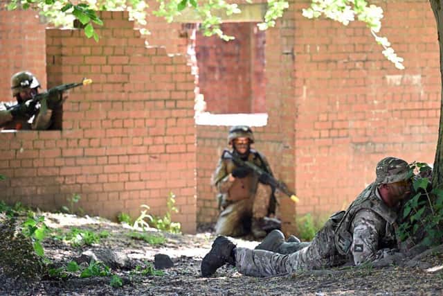 A British soldier and Ukrainian soldiers take part in urban combat exercises at a British Army military base in Northern England last week.