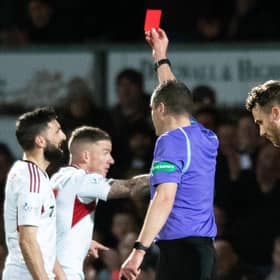 Aberdeen's Graeme Shinnie is shown a red card for his challenge on Ross County's Jack Baldwin following a VAR check. (Photo by Mark Scates / SNS Group)