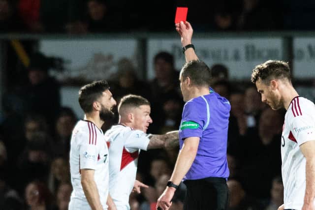 Aberdeen's Graeme Shinnie is shown a red card for his challenge on Ross County's Jack Baldwin following a VAR check. (Photo by Mark Scates / SNS Group)