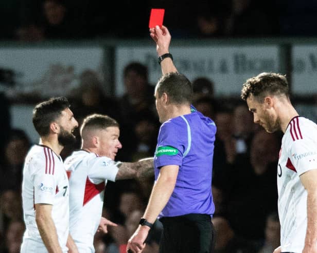 Aberdeen's Graeme Shinnie is shown a red card for his challenge on Ross County's Jack Baldwin following a VAR check. (Photo by Mark Scates / SNS Group)