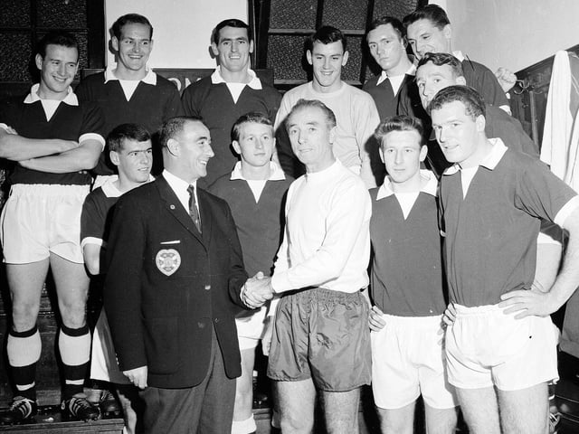 Stanley Matthews is pictured in the dressing room meeting the Hearts team and manager Tommy Walker after making his last appearance in Scotland with Stoke City in a friendly at Tynecastle on October 16, 1964.
