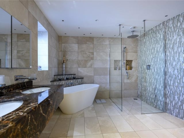 Principal bedroom en-suite with bath, shower with Aquadec tray and glass screen, double marble wash hand basins, and separate WC.