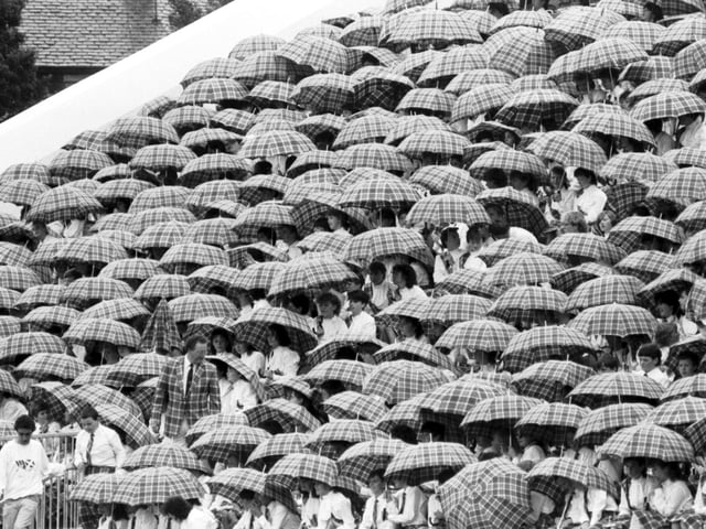 Singers were given tartan umbrellas to keep off the rain at the opening ceremony.