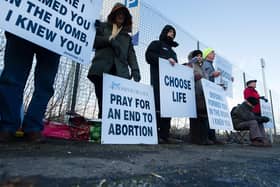 Members of the 40 Days For Life group hold a vigil as women head for appointments.